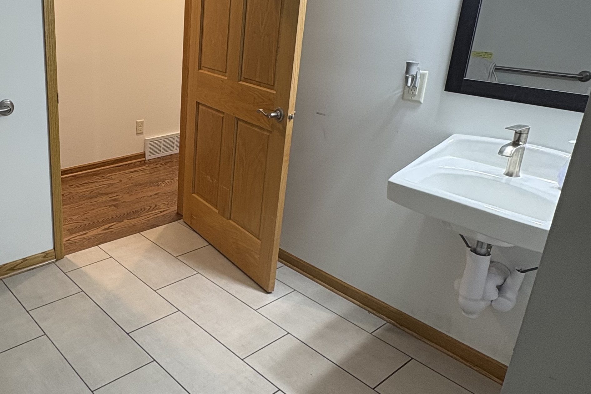 Roll-under sink and grab bar in a bathroom adapted for easier use