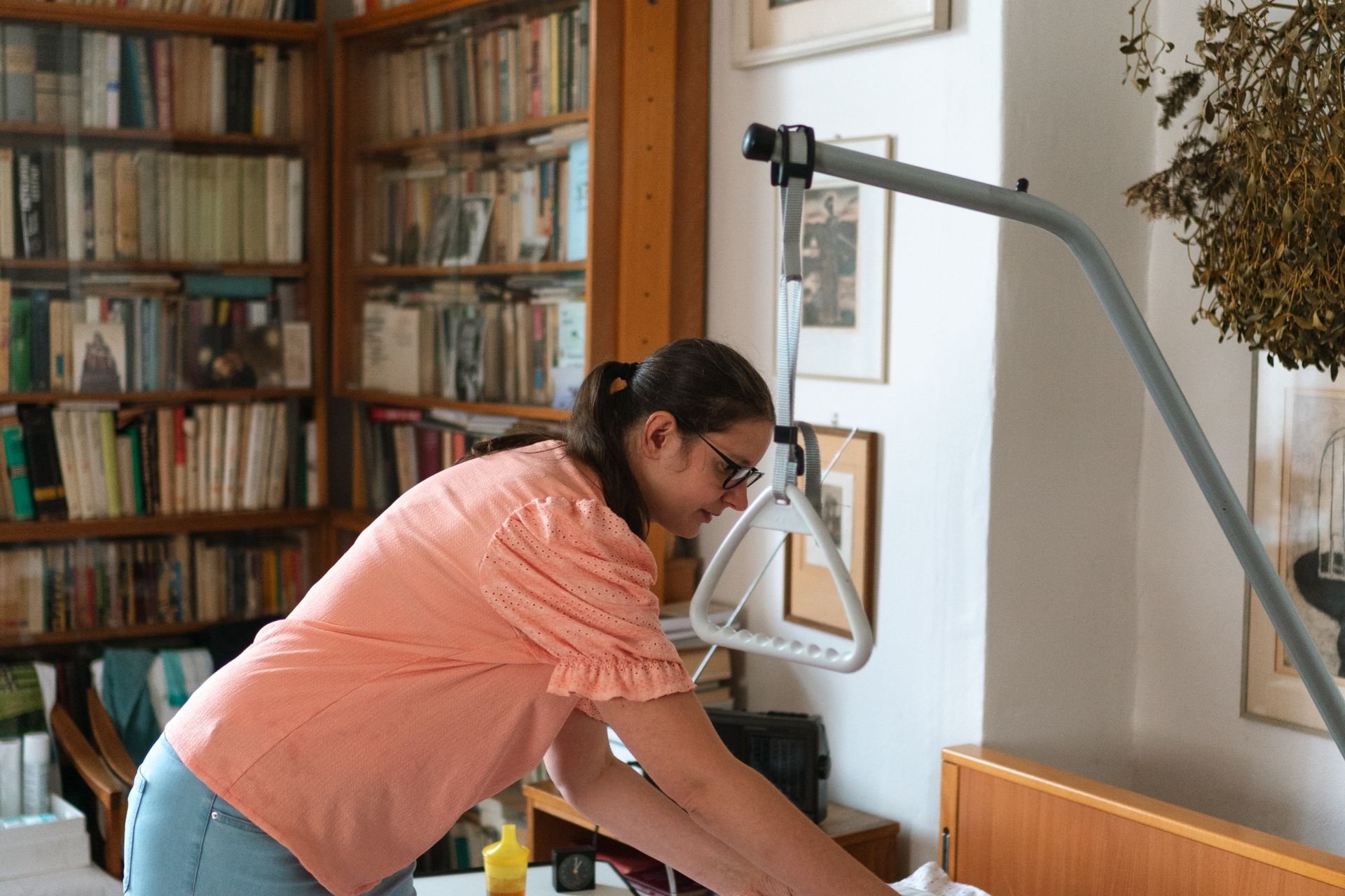 Caregiver making up an adjustable bed