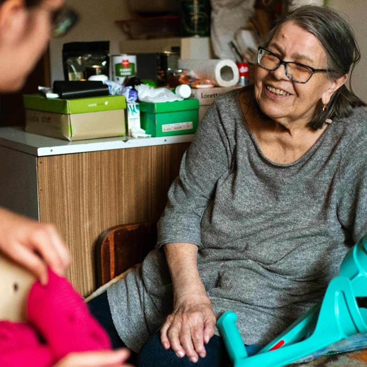 An older woman sharing a laugh with her caregiver